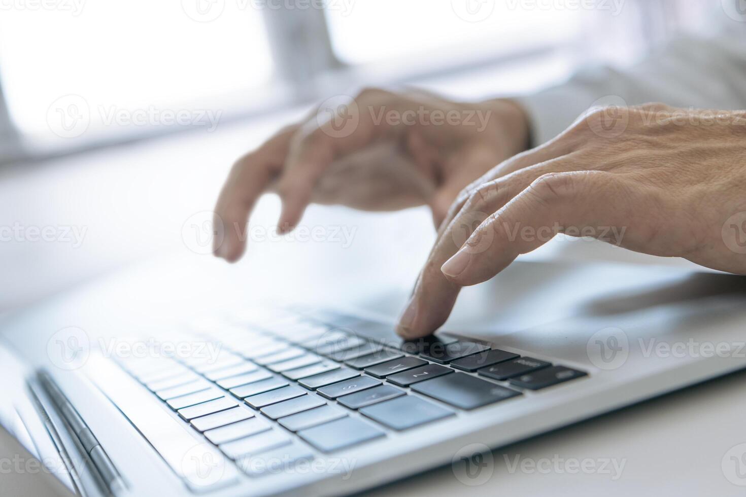 Typing on a laptop computer keyboard as data input photo