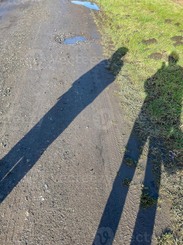two shadows of people on the street photo