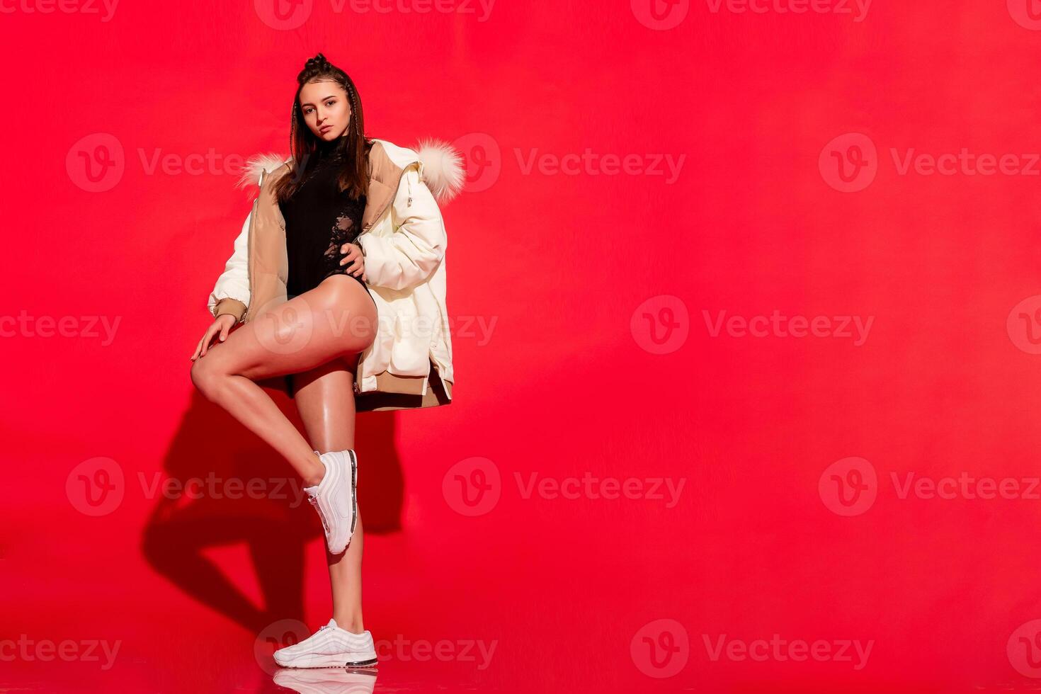 girl white jacket poses red background photo