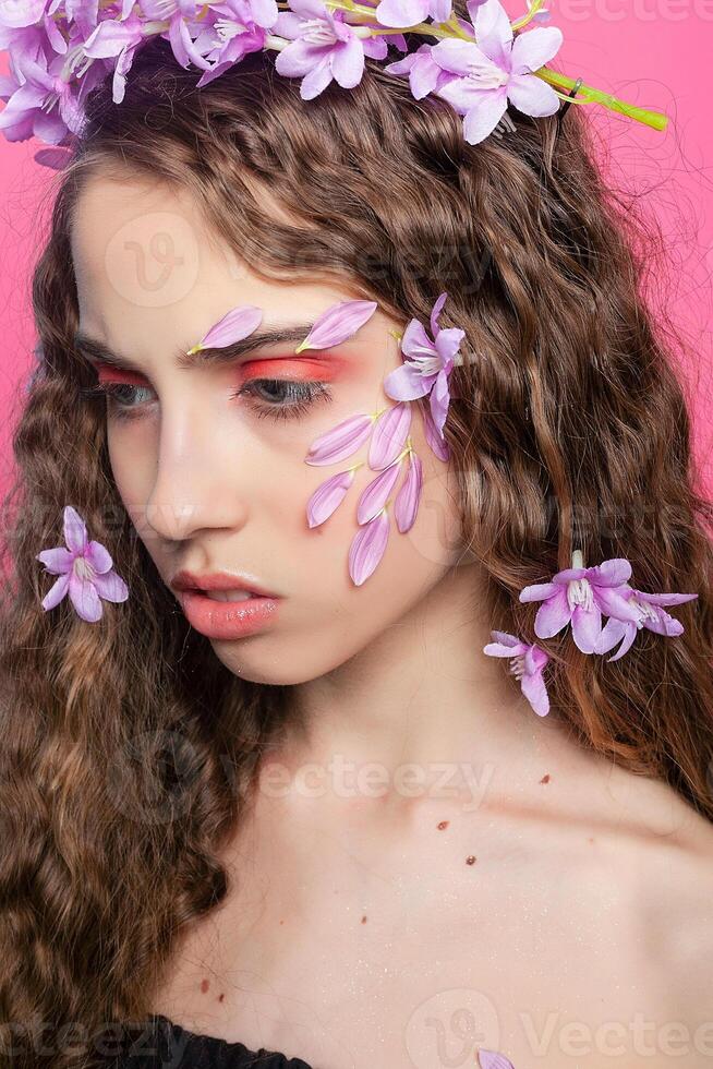 Beautiful girl with flowers in in hair photo