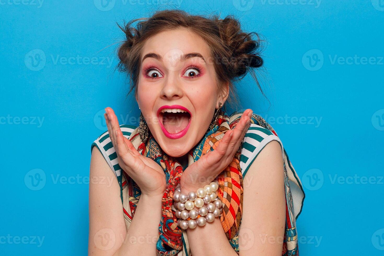 The portrait of young woman with shocked facial expression photo