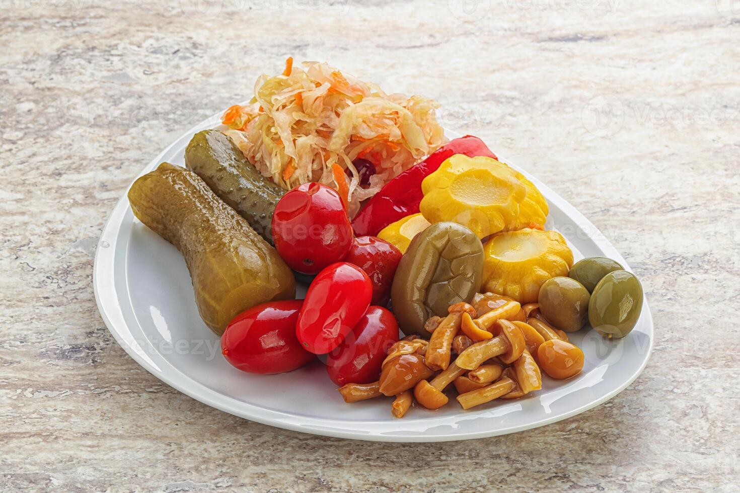 Plate with pickled vegetables and mushrooms photo