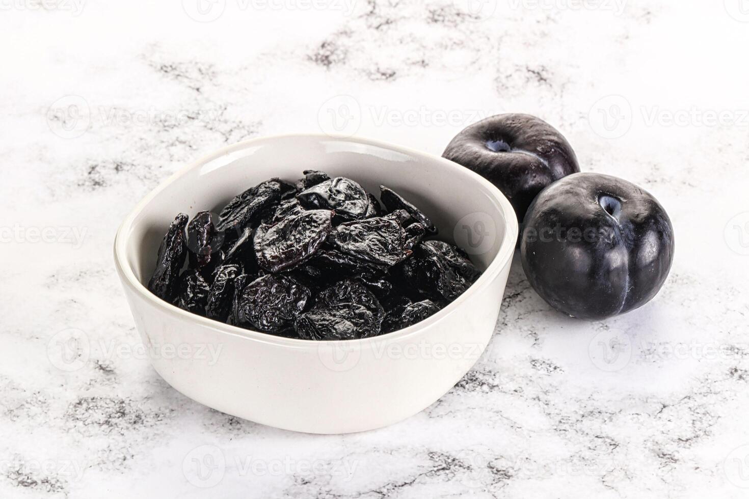 Dry prunes in thw bowl photo