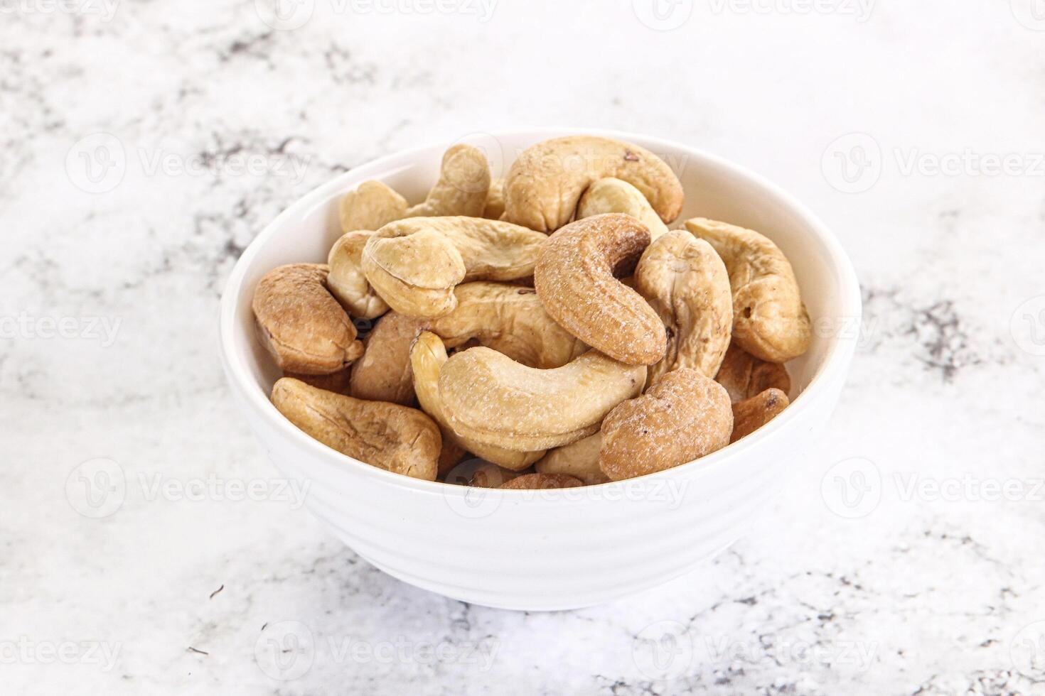 Cashew nuts heap in the bowl photo