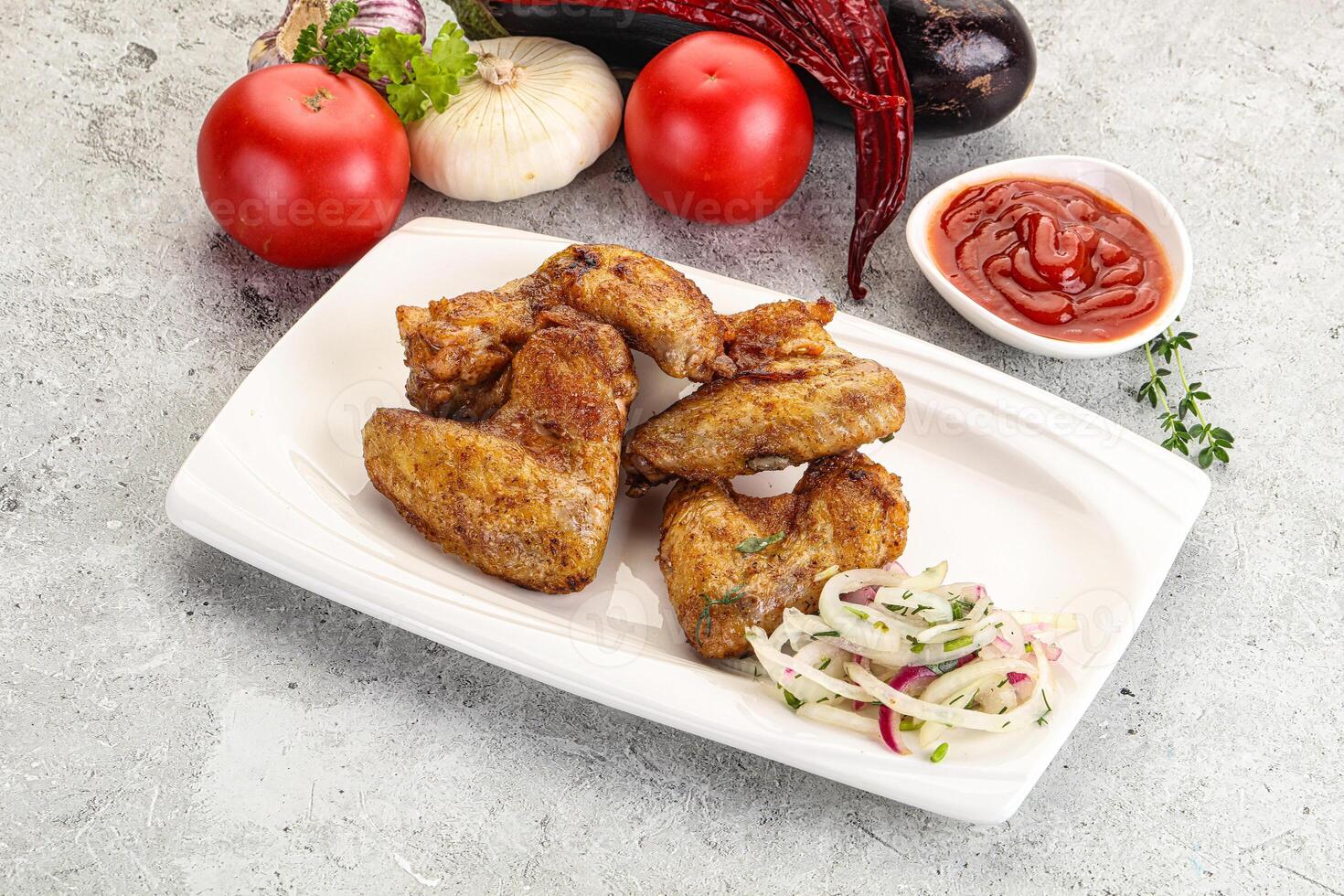 Grilled chicken wings with sauce photo