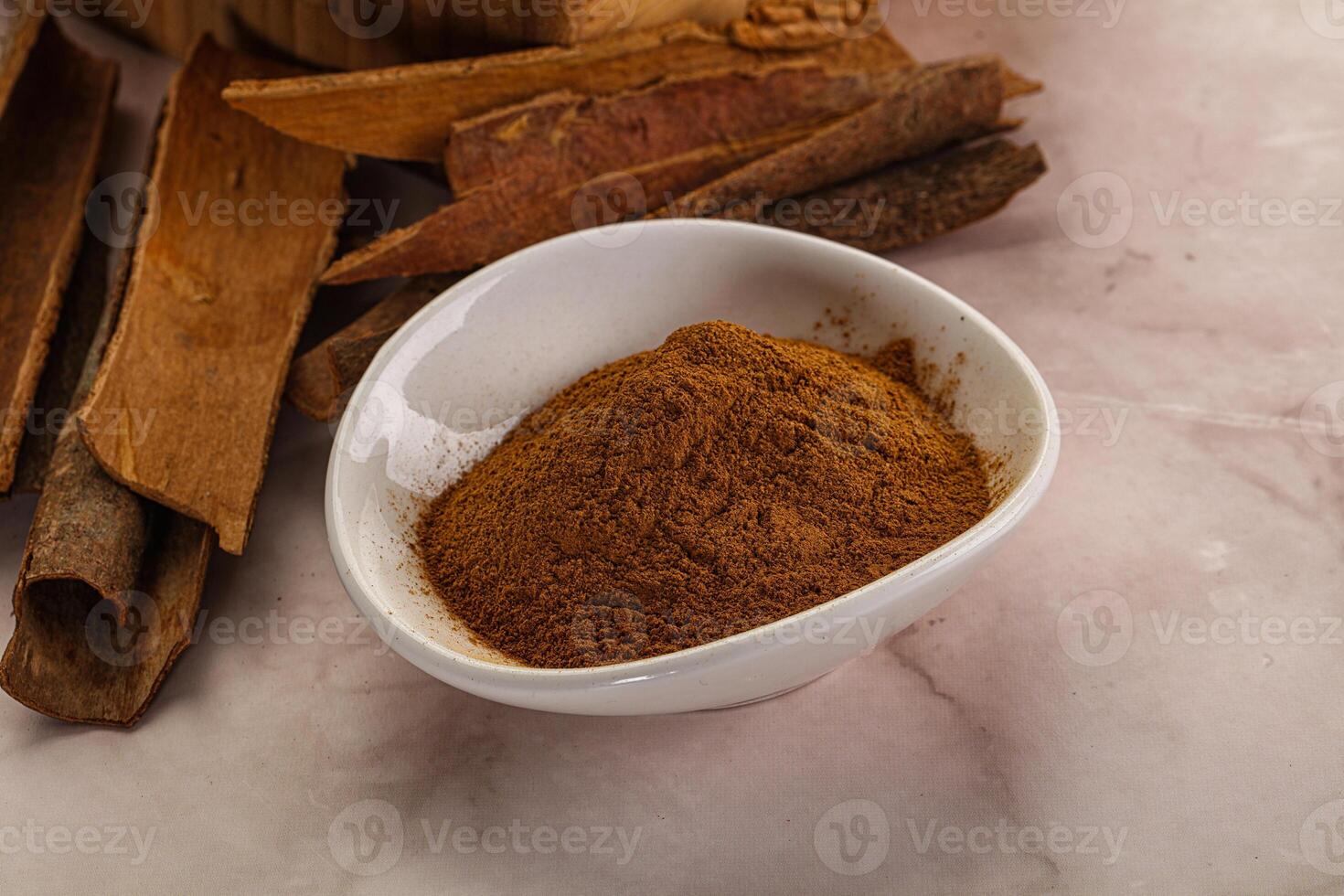 Natural Cinnamon powder with sticks photo