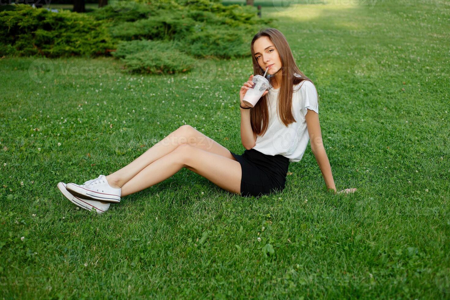 Portrait of a young brunette woman in a white T-shirt photo