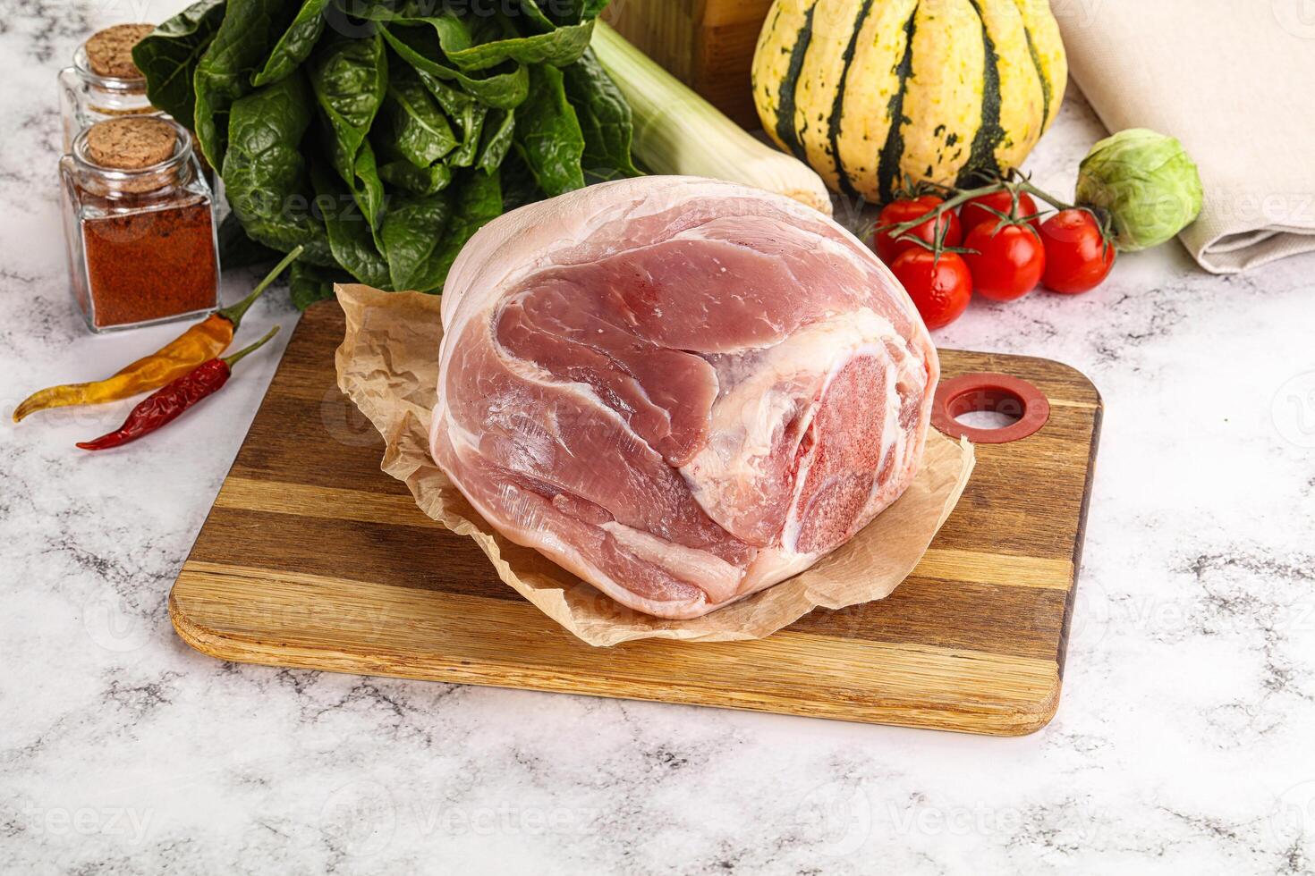 Uncooked raw pork knuckle with spices photo