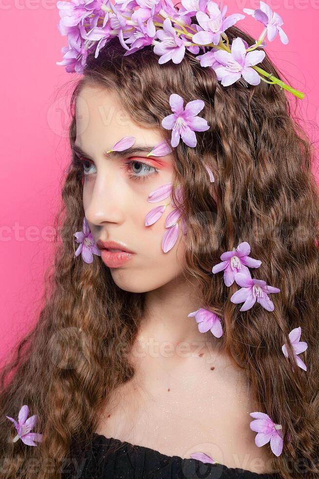 Beautiful girl with flowers in in hair photo