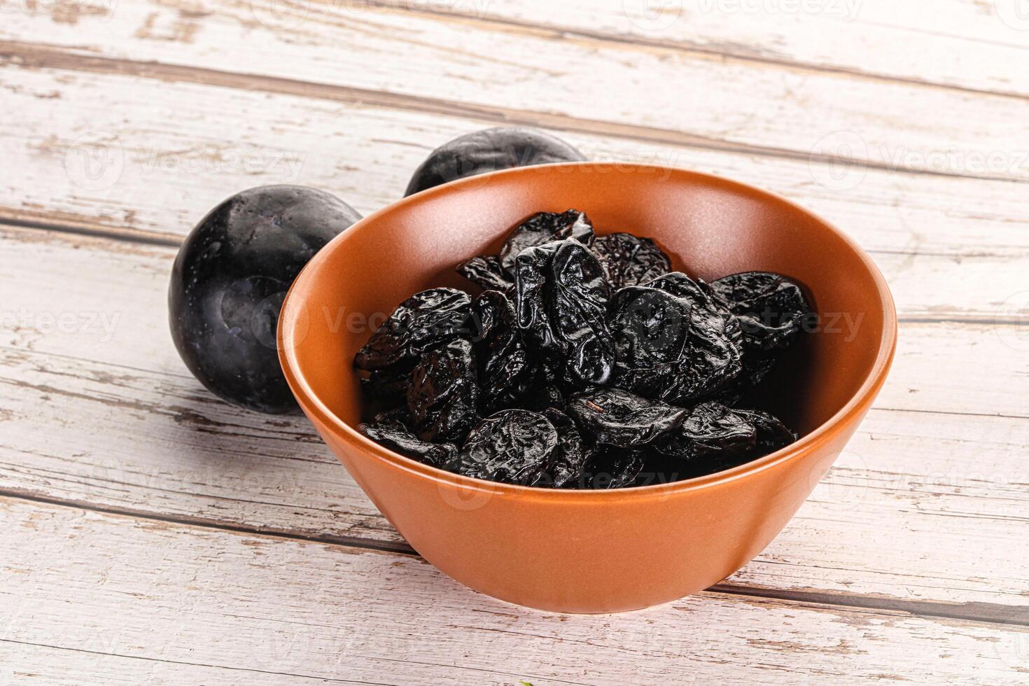 Dry prunes in thw bowl photo