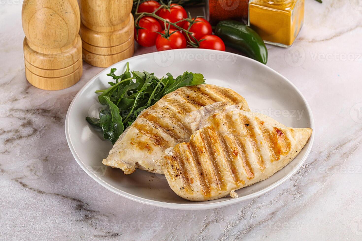 Grilled chicken breast served arugula photo