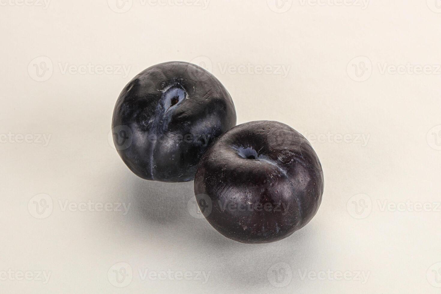 Two ripe sweet black plums photo