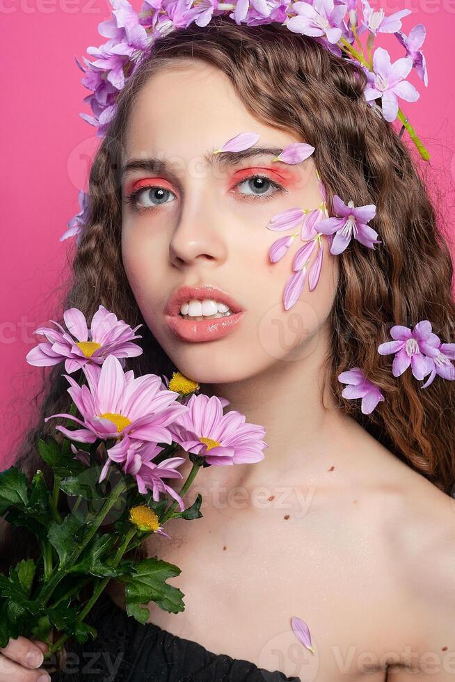 Beautiful girl with flowers in in hair photo