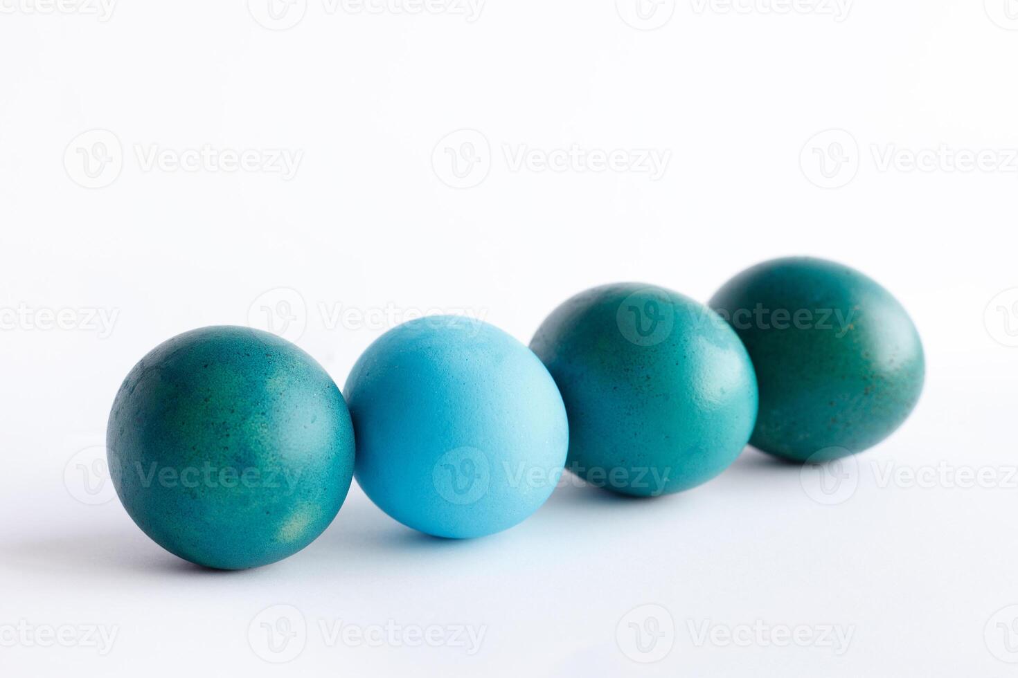 Row of ombre blue Easter eggs isolated on white background photo