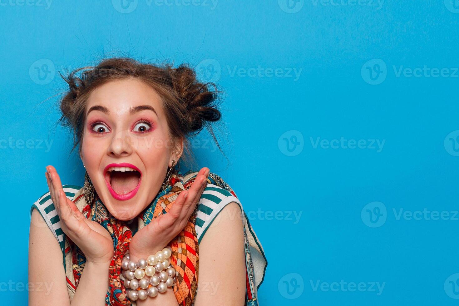 The portrait of young woman with shocked facial expression photo