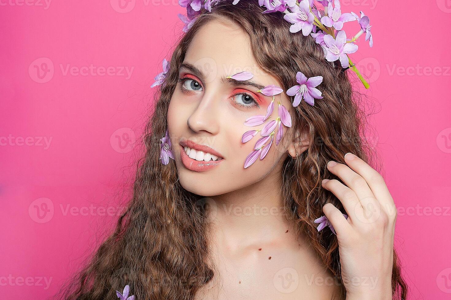 Beautiful girl with flowers in in hair photo