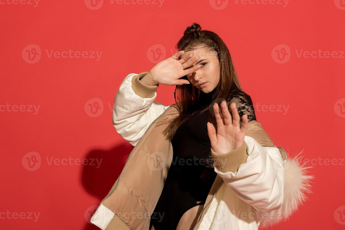 girl white jacket poses red background photo