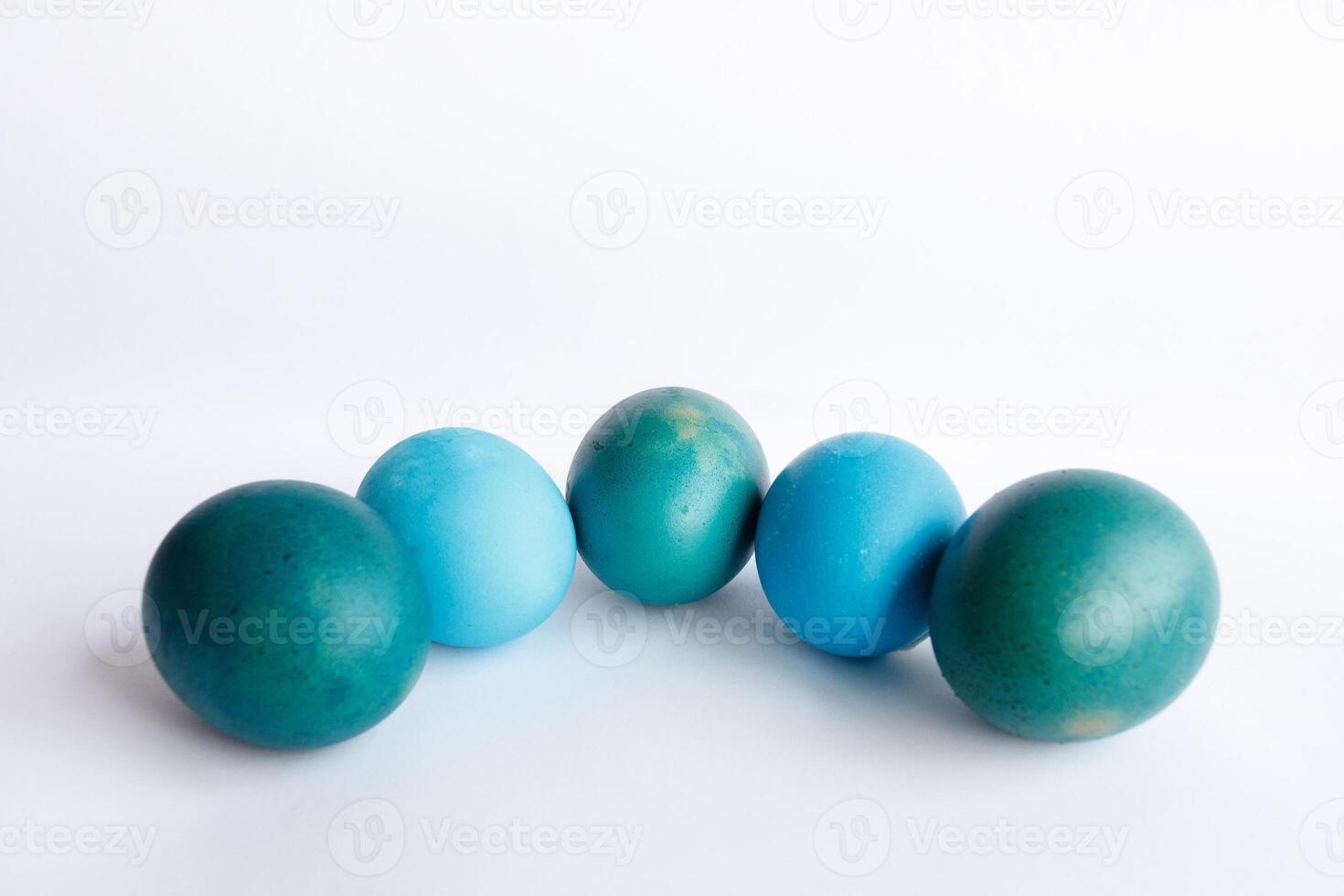 Row of ombre blue Easter eggs isolated on white background photo