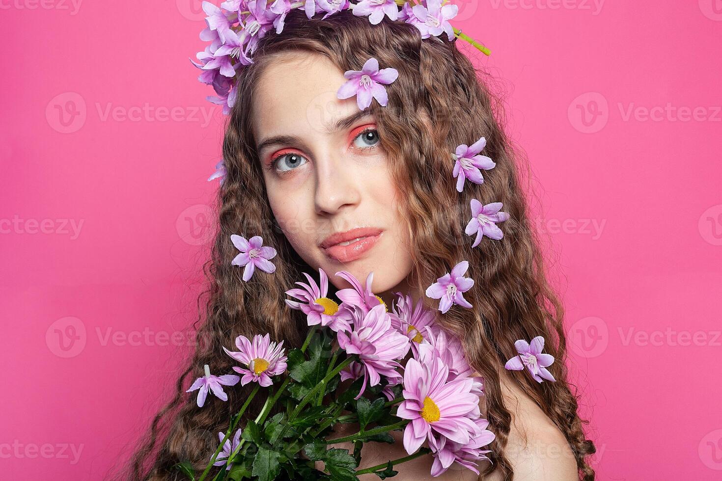 Beautiful girl with flowers in in hair photo