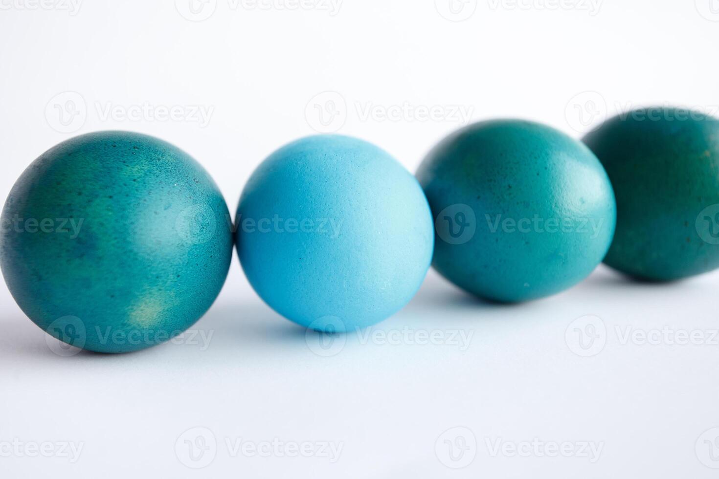 Row of ombre blue Easter eggs isolated on white background photo