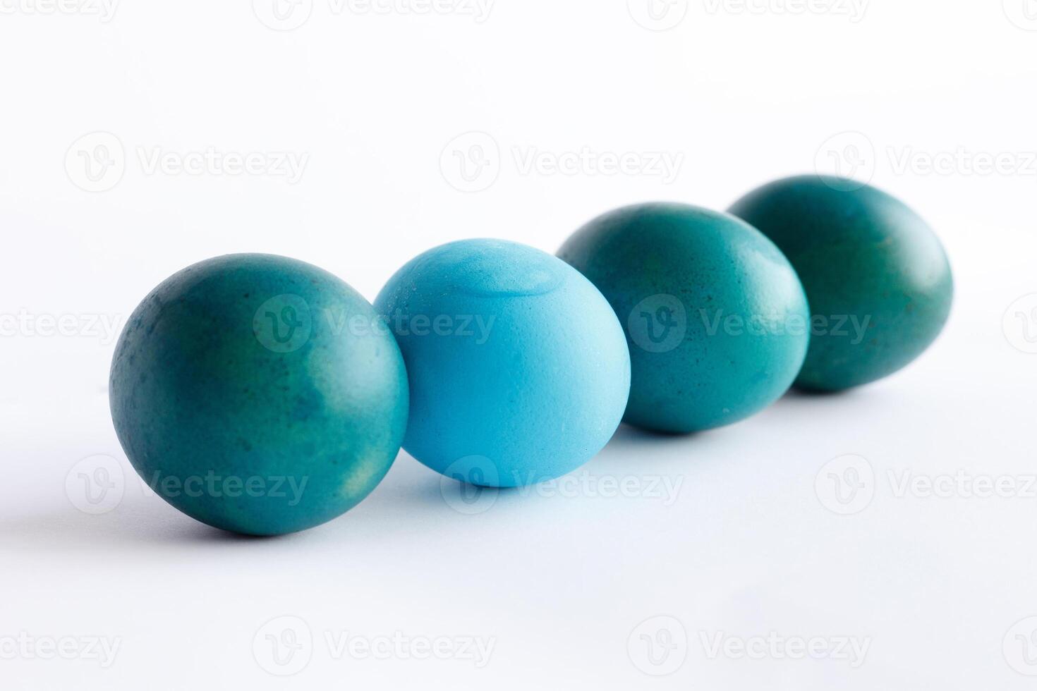 Row of ombre blue Easter eggs isolated on white background photo