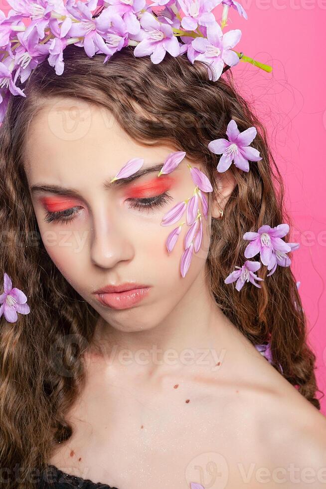 Beautiful girl with flowers in in hair photo