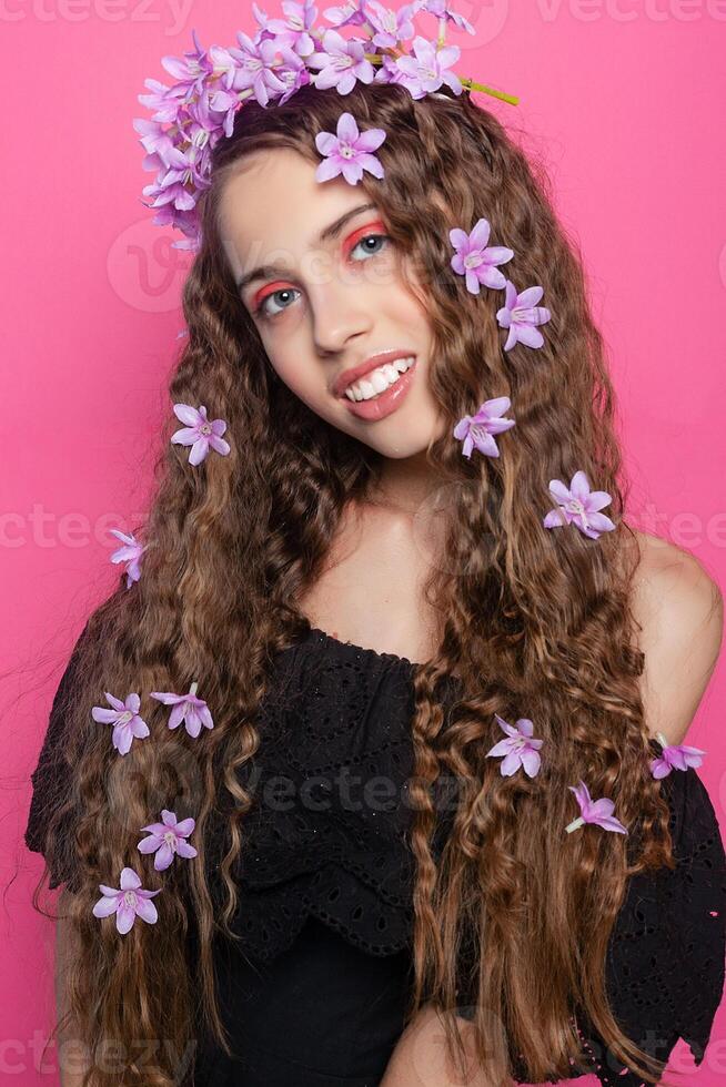 Beautiful girl with flowers in in hair photo