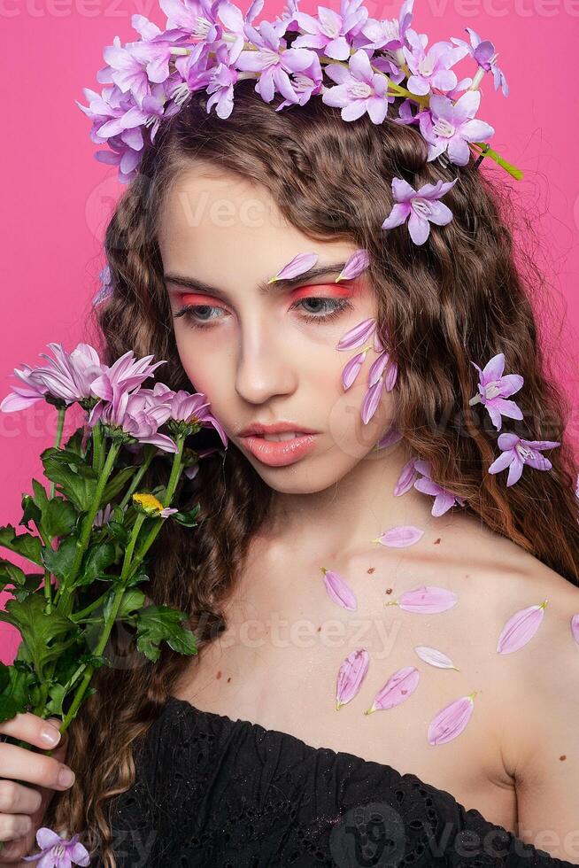 Beautiful girl with flowers in in hair photo