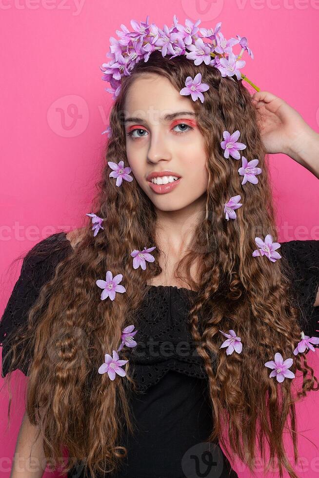 Beautiful girl with flowers in in hair photo