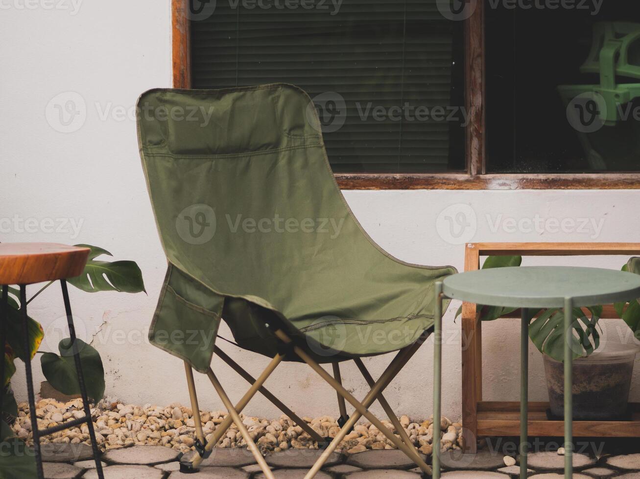 Camping chairs and white house at Thailand photo