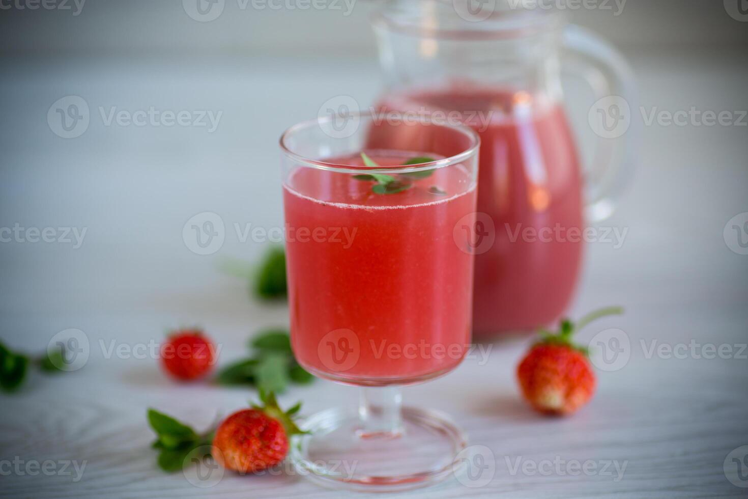 Cold summer strawberry kvass with mint in a glass photo