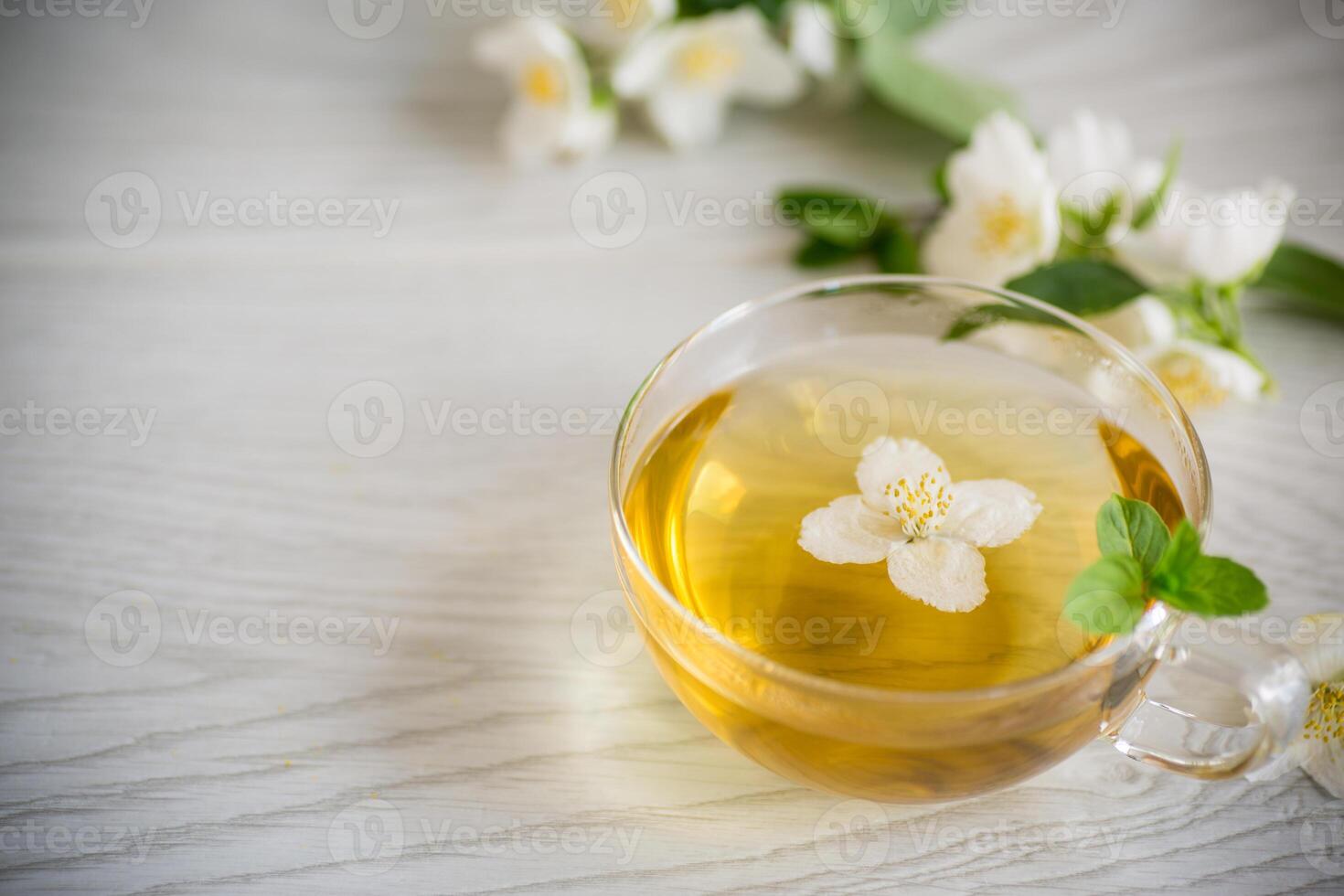 Composition with cup of jasmine tea and flowers photo