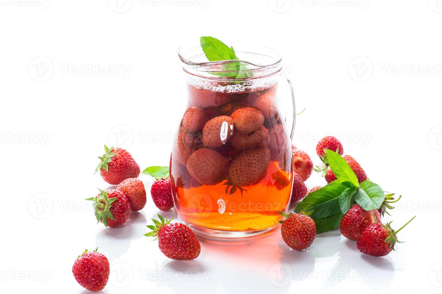 Sweet refreshing berry compote of ripe strawberries in a decanter photo