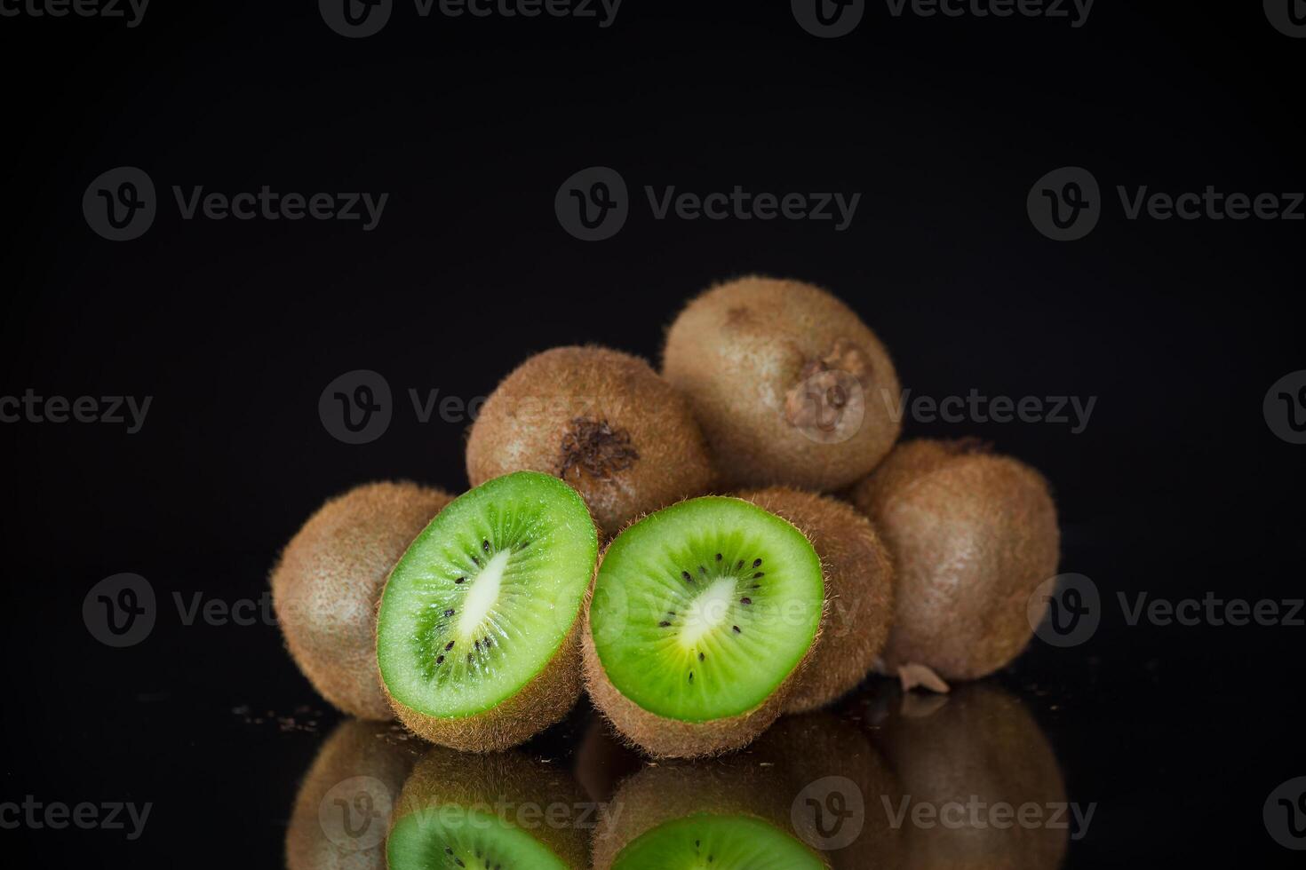 Kiwi fruit slice closeup on black background photo