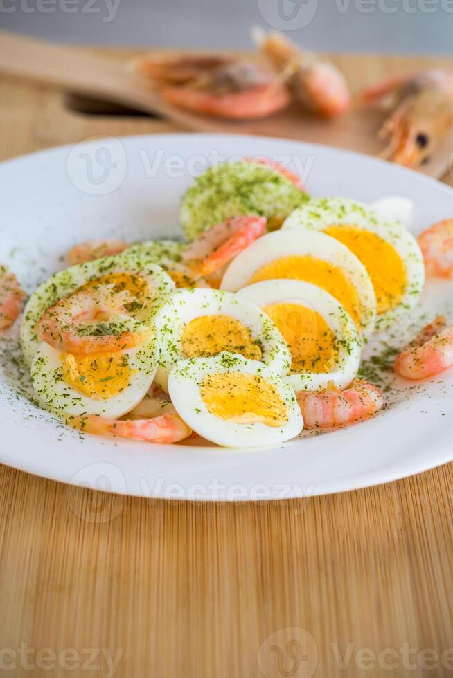 boiled eggs with boiled shrimp in a plate for breakfast photo
