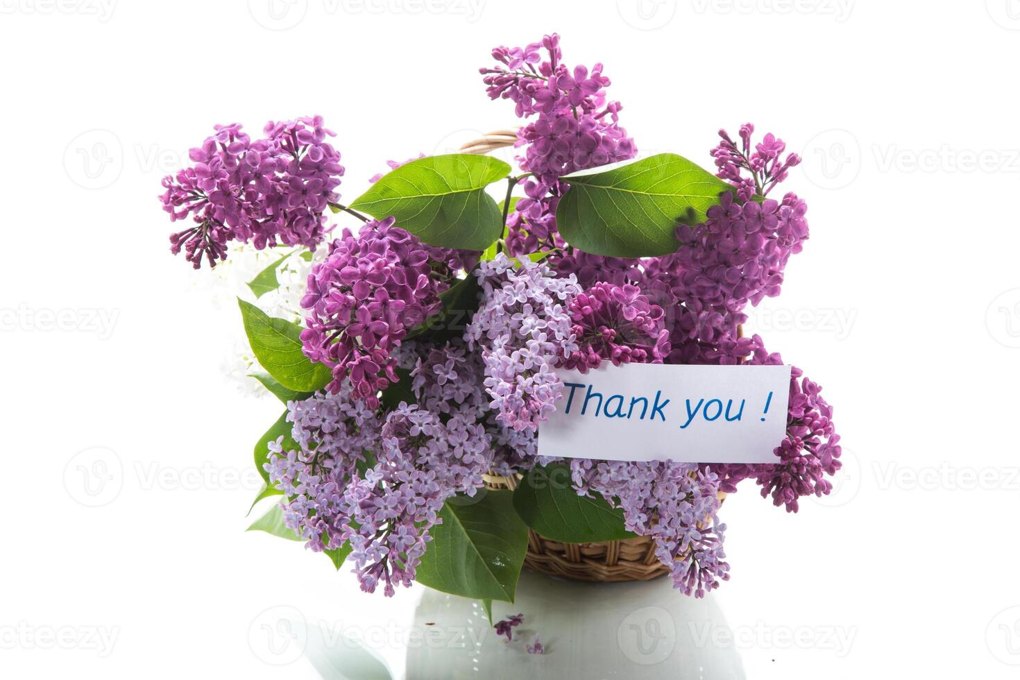 bouquet of different blooming spring lilacs in basket on white background photo