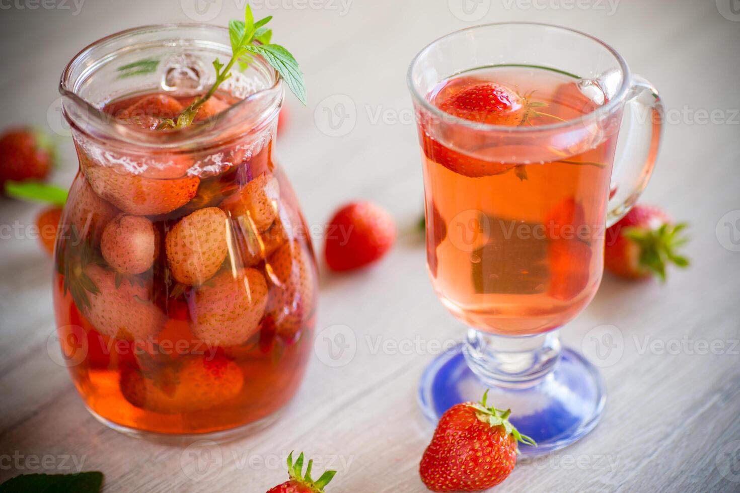 Sweet refreshing berry compote of ripe strawberries in a decanter photo