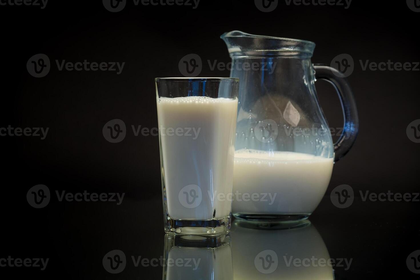 fresh natural milk in a glass and in a glass decanter photo