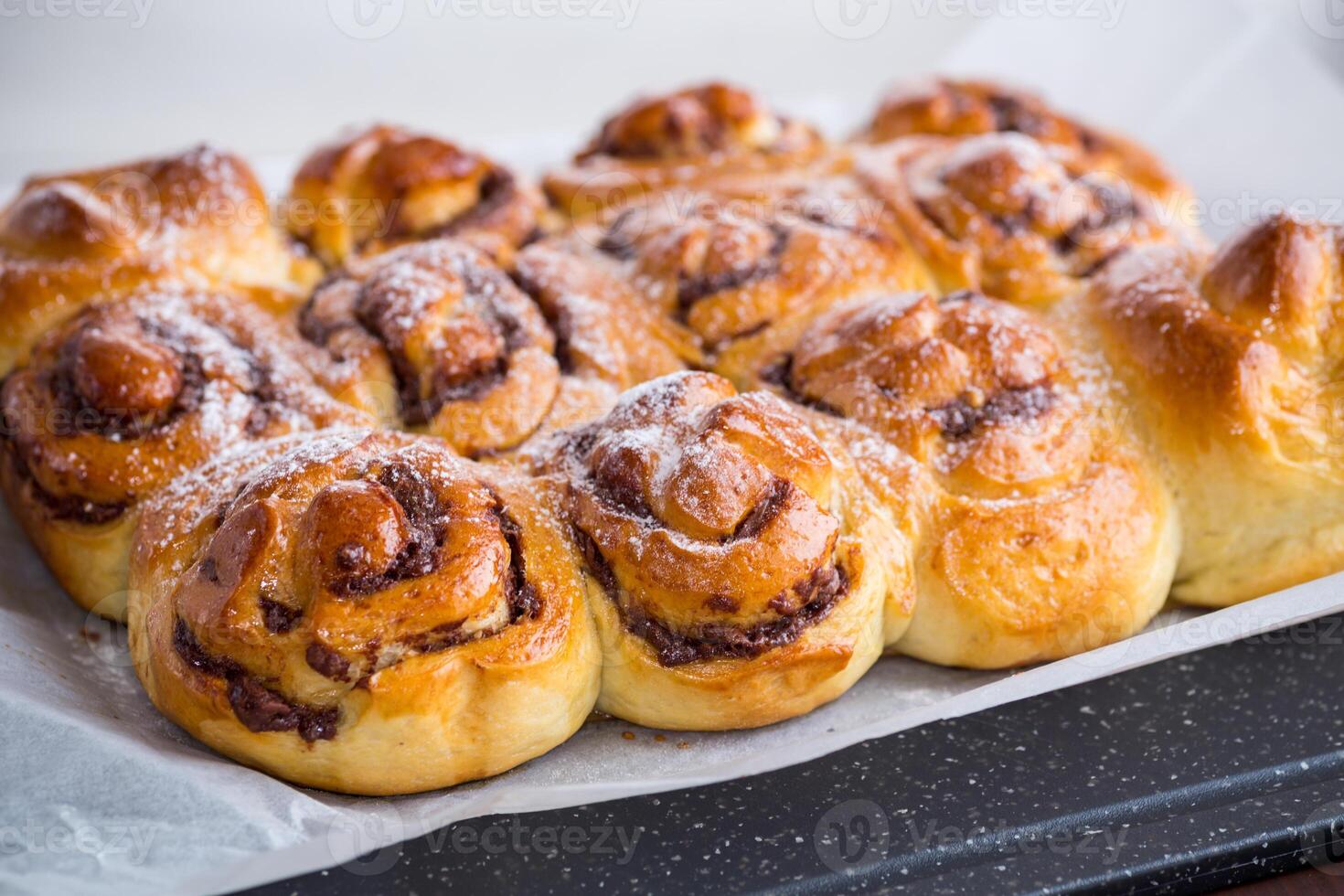 cooked baked sweet bun rolls with chocolate filling photo