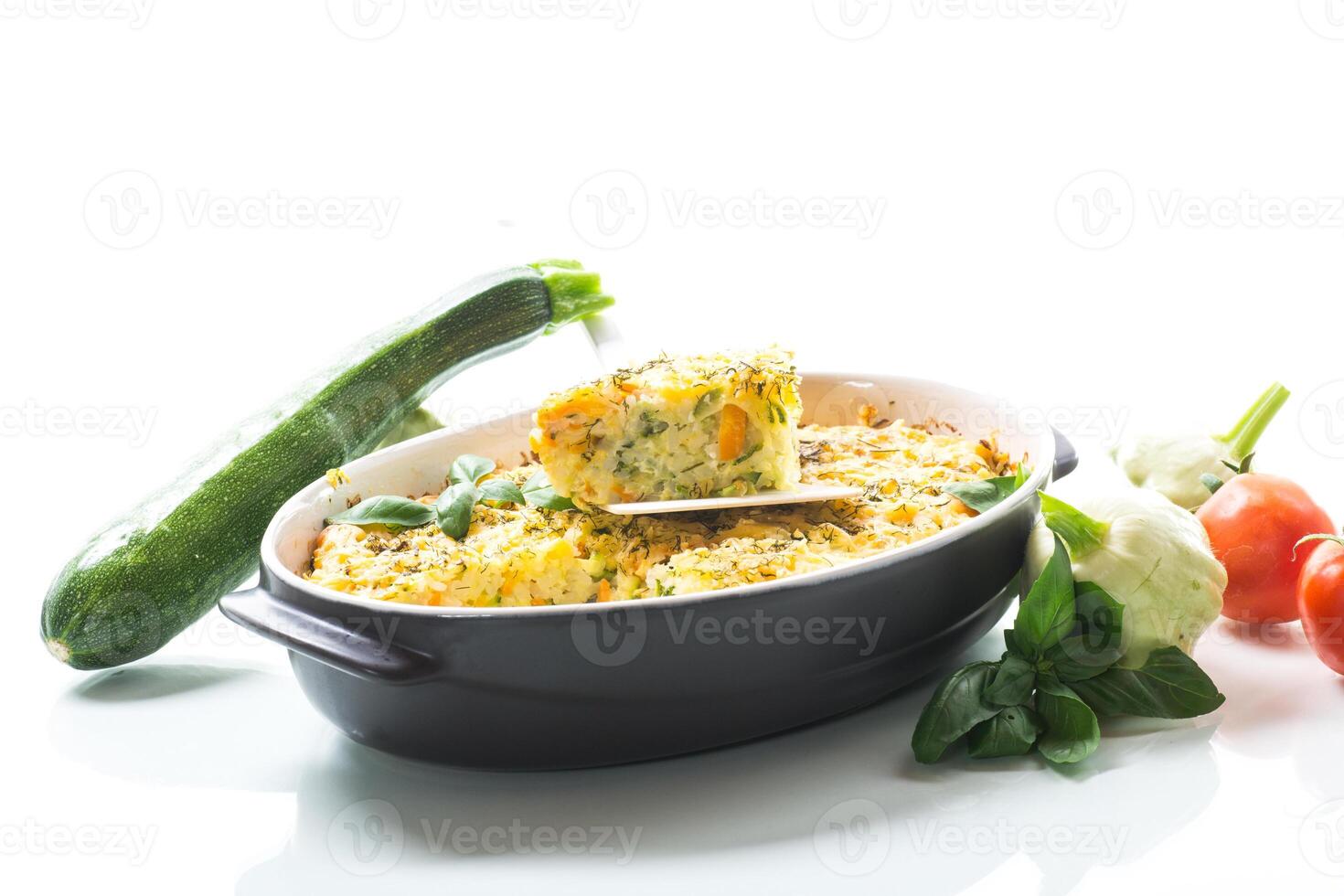 vegetable casserole of patissons, zucchini, carrots in a ceramic form . photo