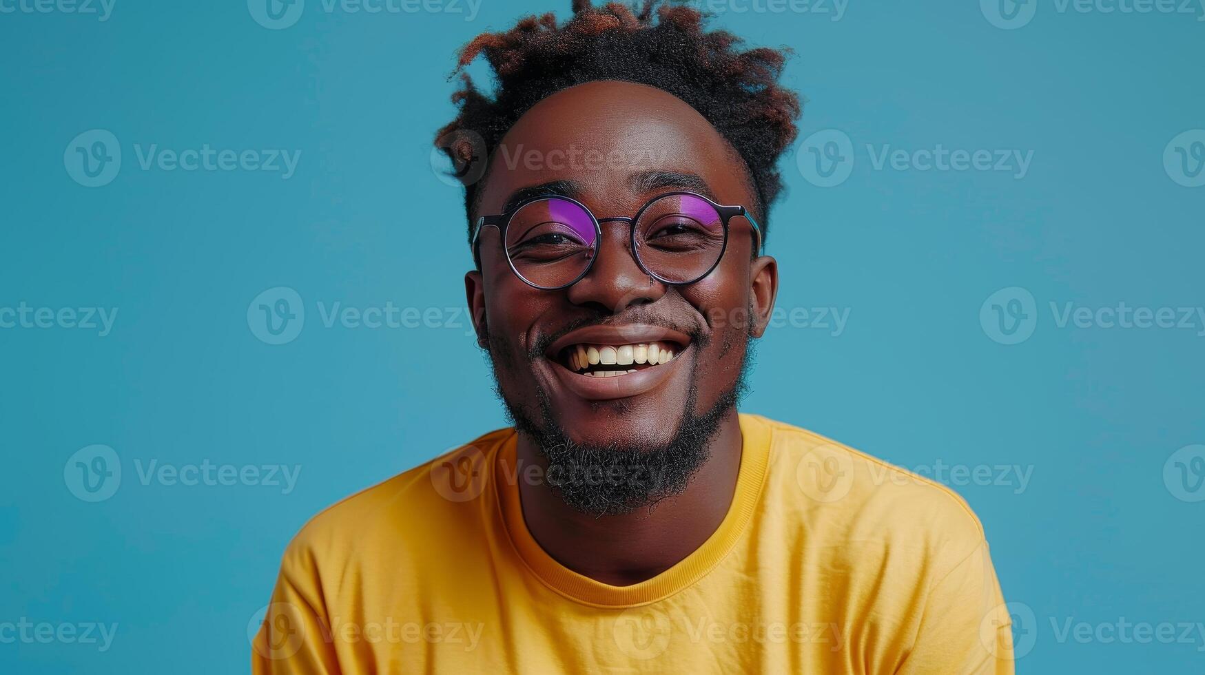 AI Generated Black millennial man with glasses and casual clothing isolated on blue studio background with modern cellphone in hand. Happy biracial male client excited with new smartphone application photo