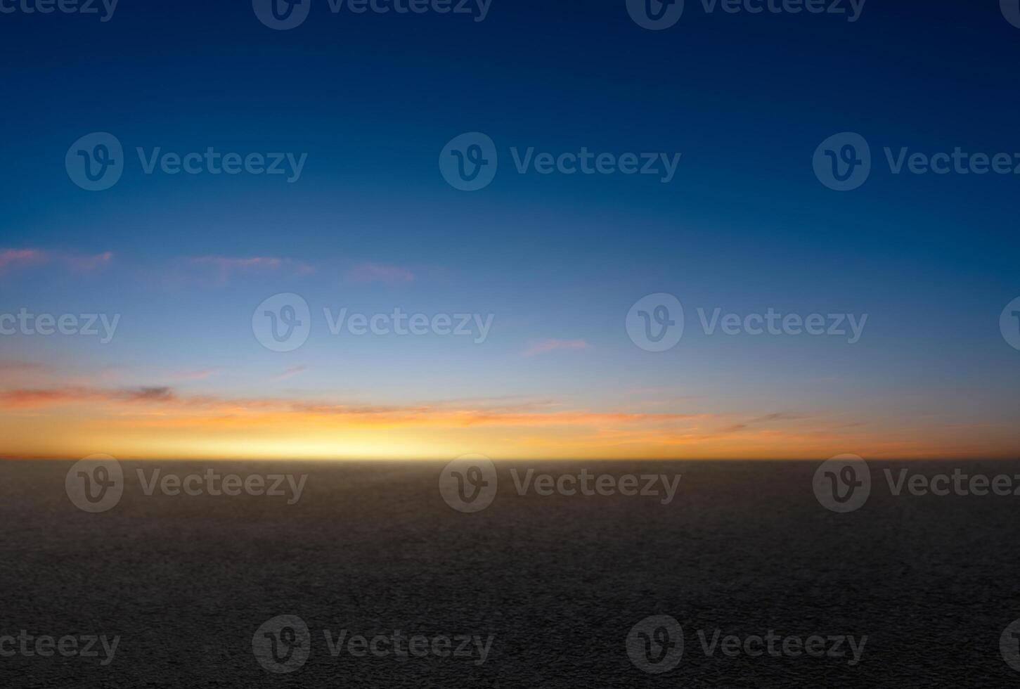 Sunset Sky,Cloud Background,Horizon Evening Summer twilight dusk sky with gloomy vivid blue, yellow, orange with sunlight reflecting on dark concrete floor texture or rough asphalt street pavement photo