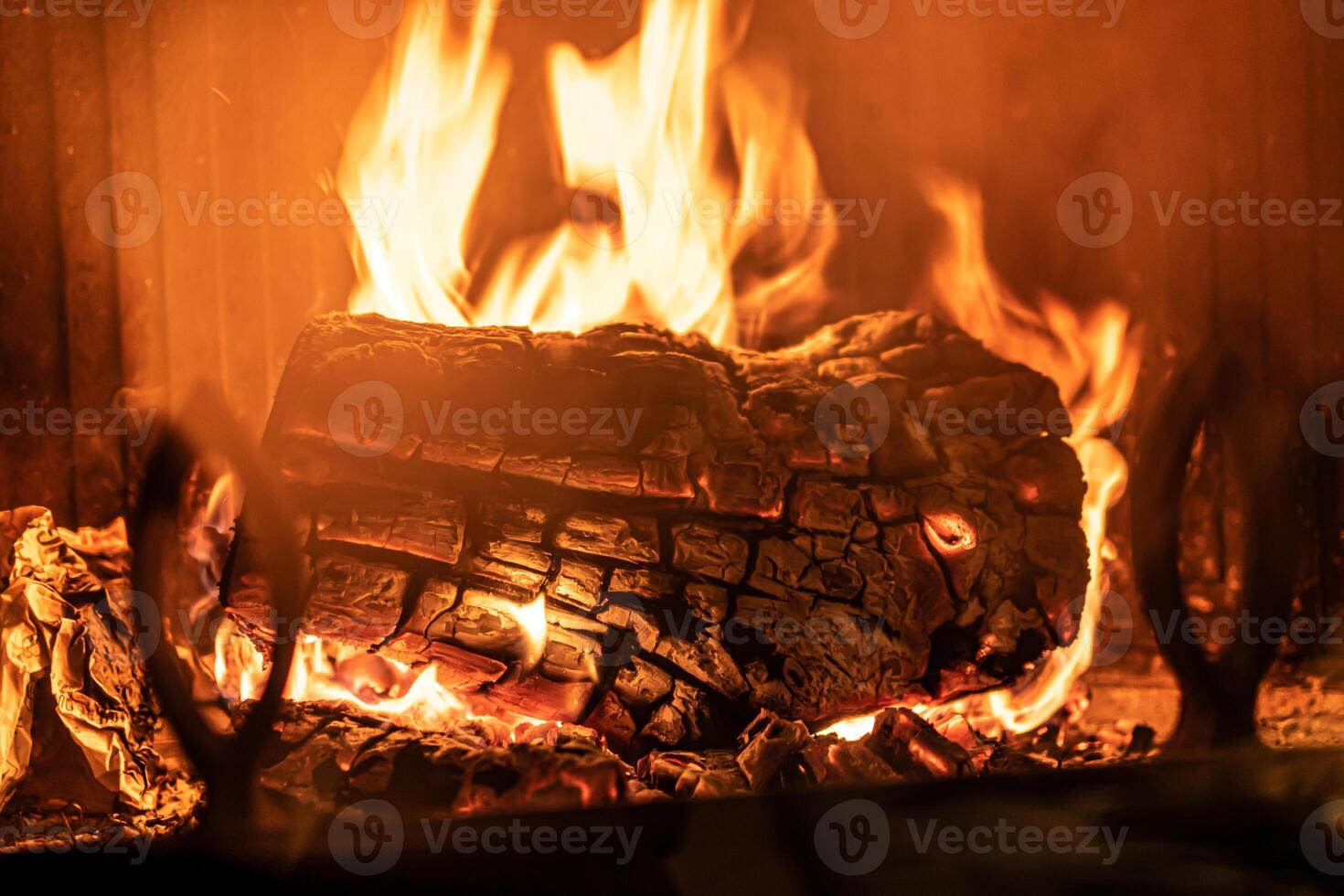 Log of wood burning in a fireplace inside a house, hearth photo