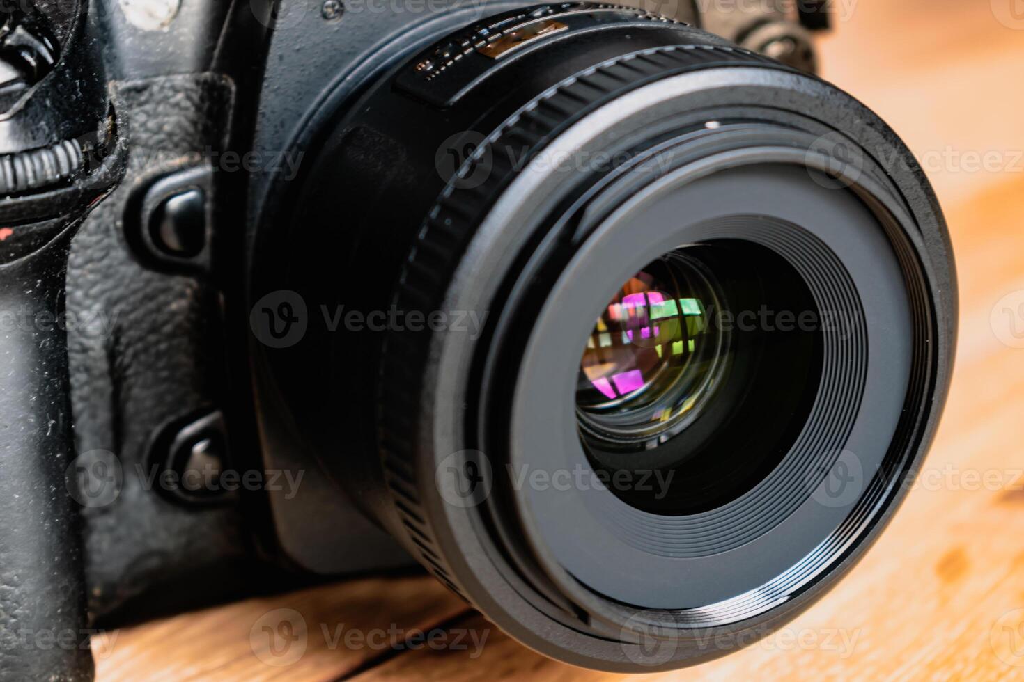 Reflex camera or dslr with reflexion on lens, photograph equipment, for professionnal and agency photo