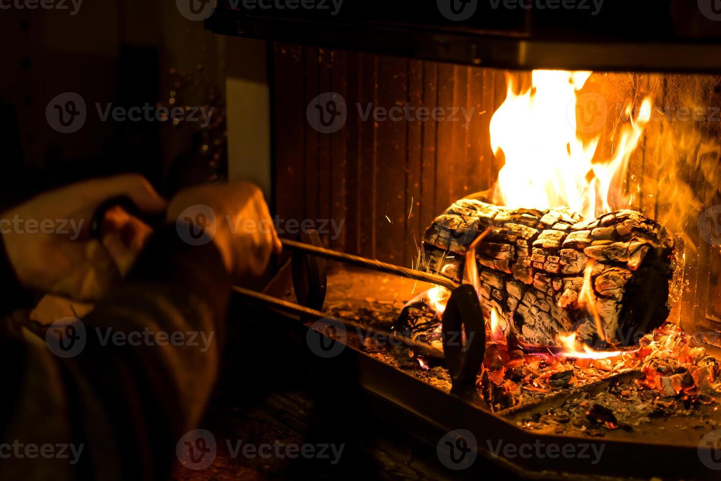 Log of wood burning in a fireplace inside a house, hearth photo