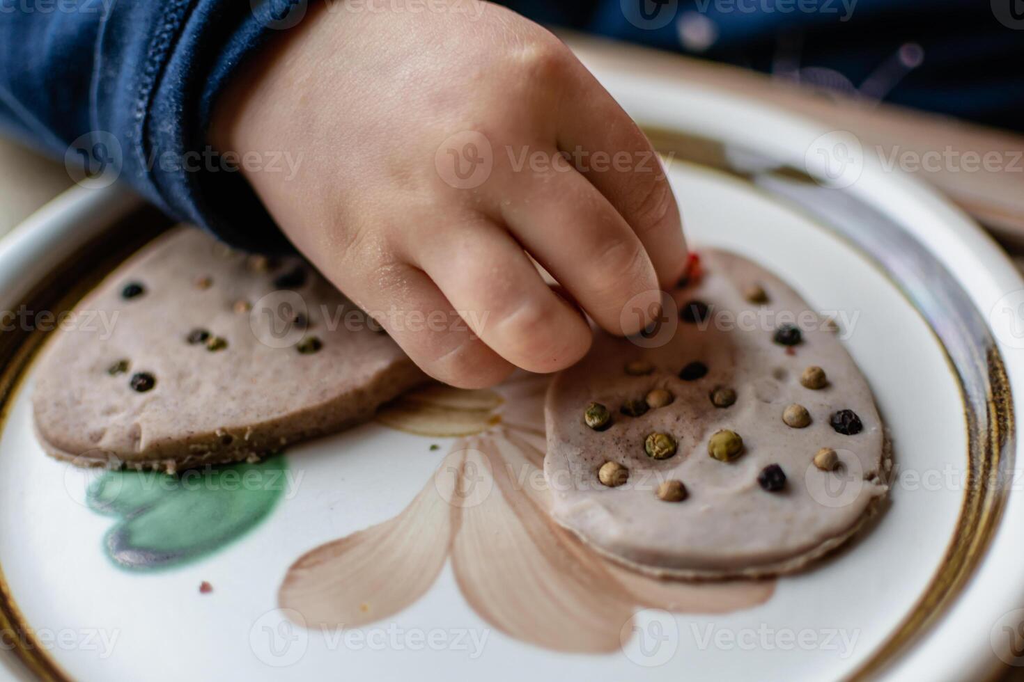 Child having fun modeling salt dough, authentic activity, fine motor skills development photo