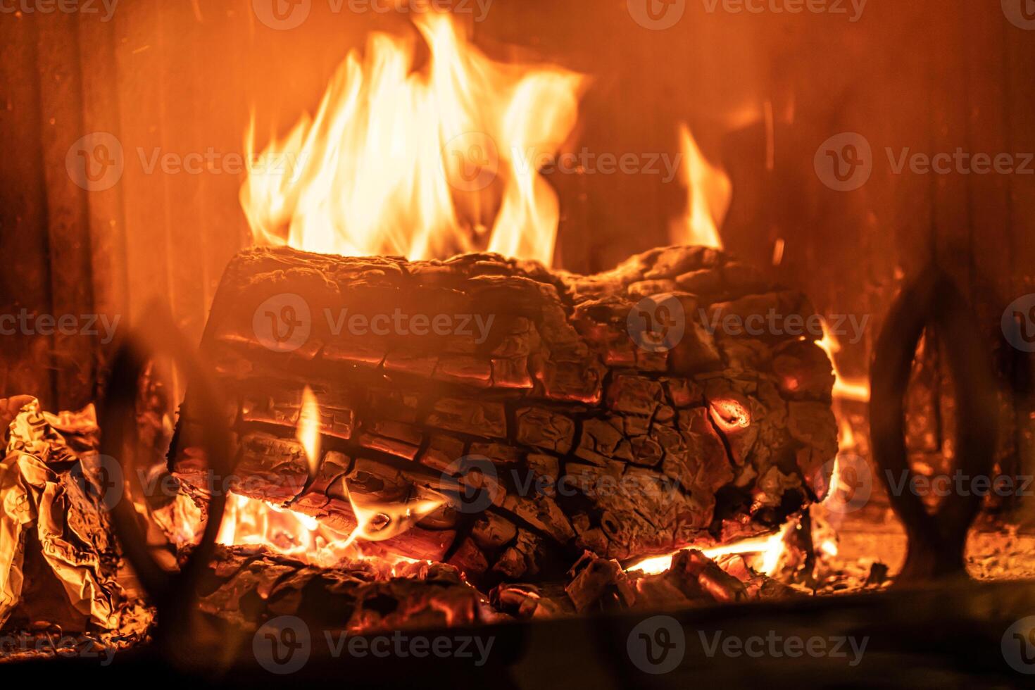 Log of wood burning in a fireplace inside a house, hearth photo
