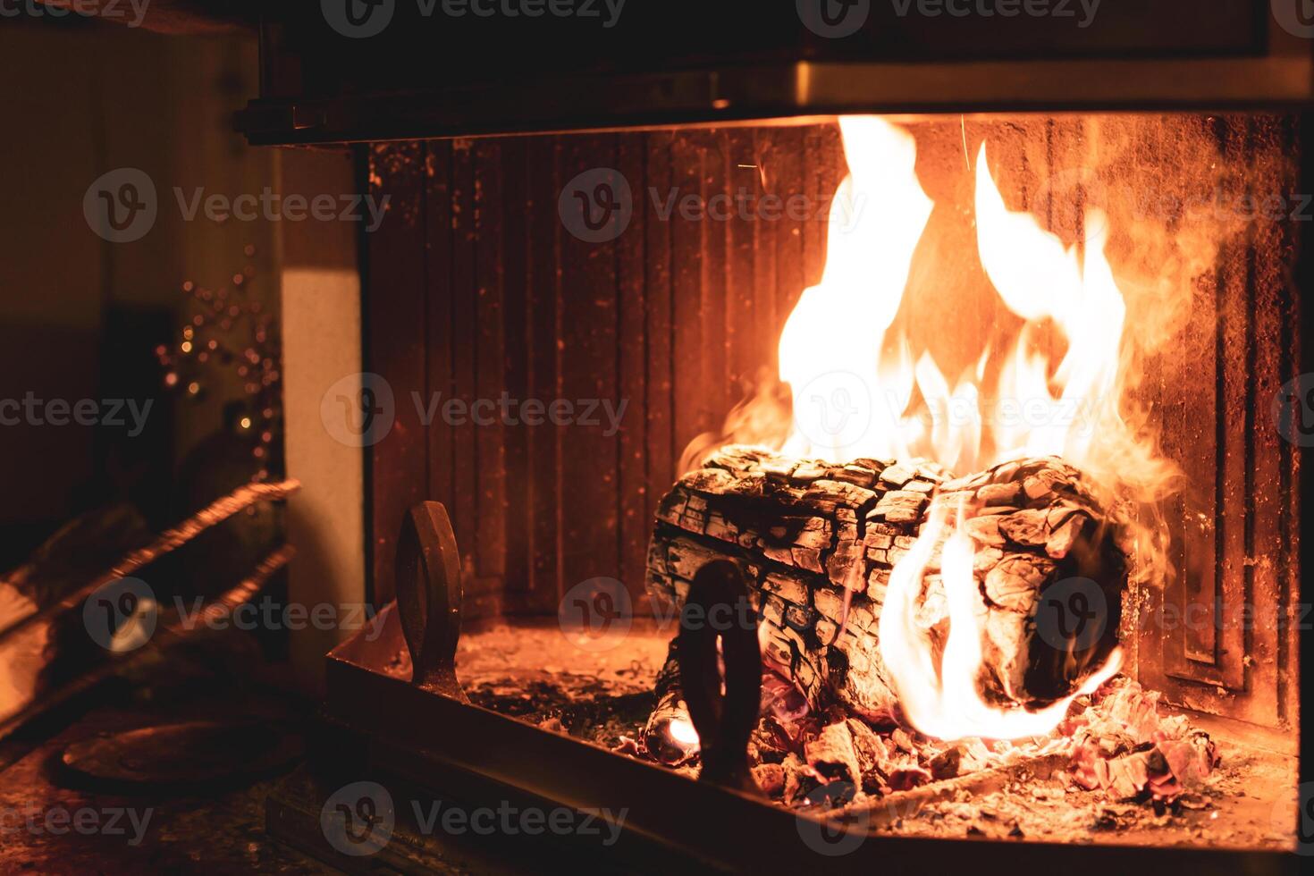 Log of wood burning in a fireplace inside a house, hearth photo