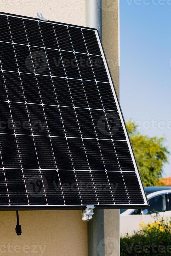 Solar panels on a well-exposed wall of an individual house, making savings following the energy crisis, eco-citizen gesture, green energy photo