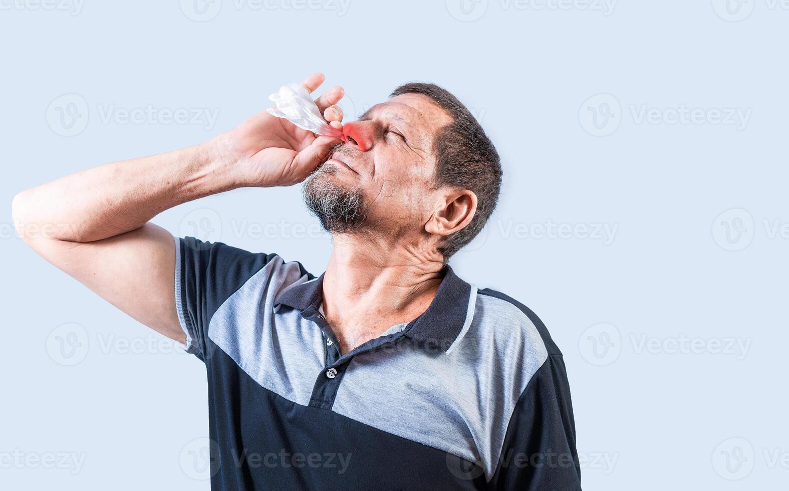 Person with nasal congestion, Senior man with irritated nose isolated. man with red nose cold, concept of sinusitis photo